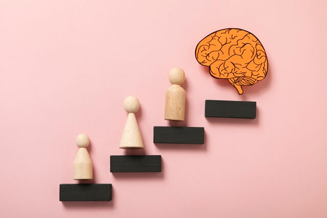 top-view-wooden-pawns-paper-brain